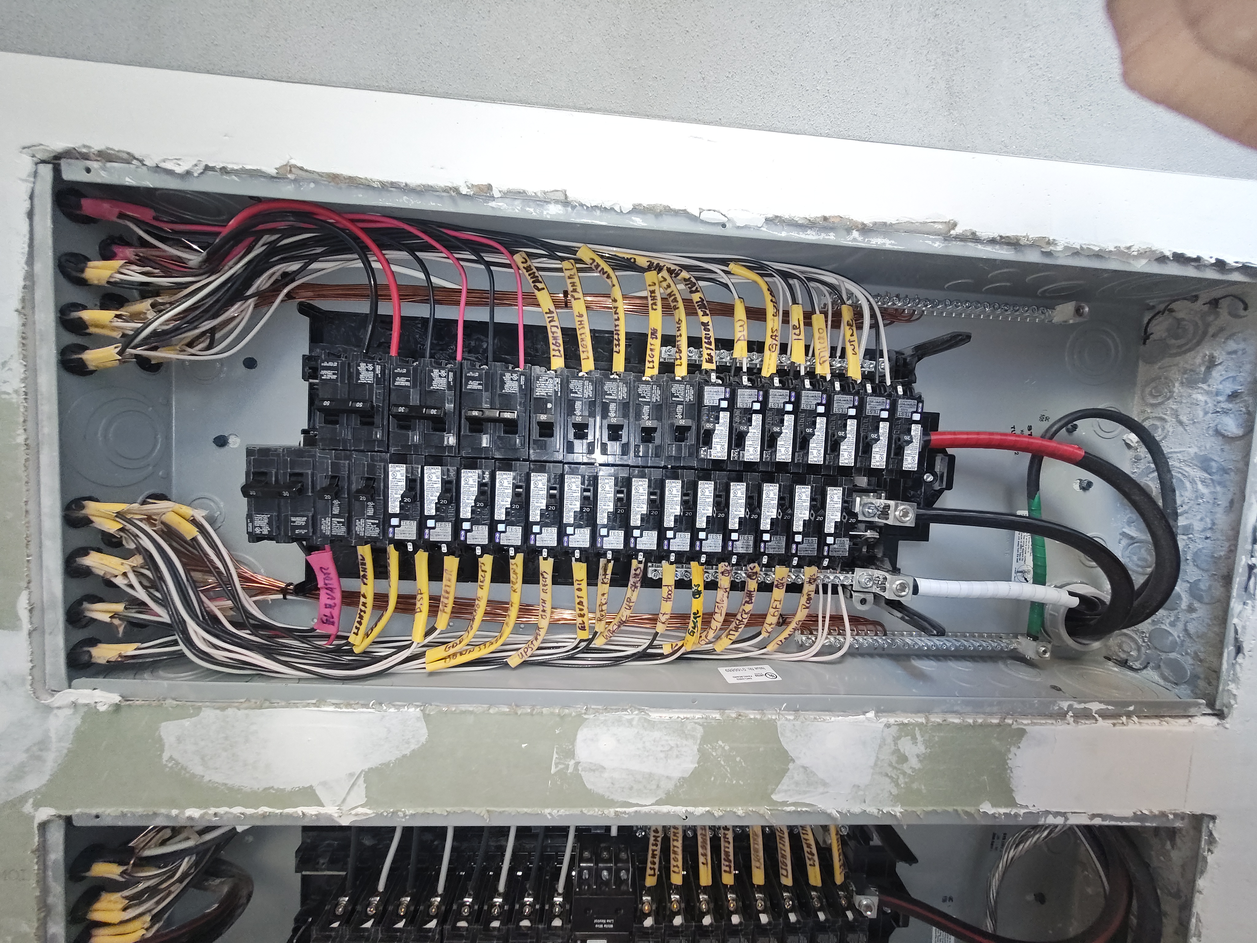 Branch circuits neatly terminated in a breaker panel during rough-in