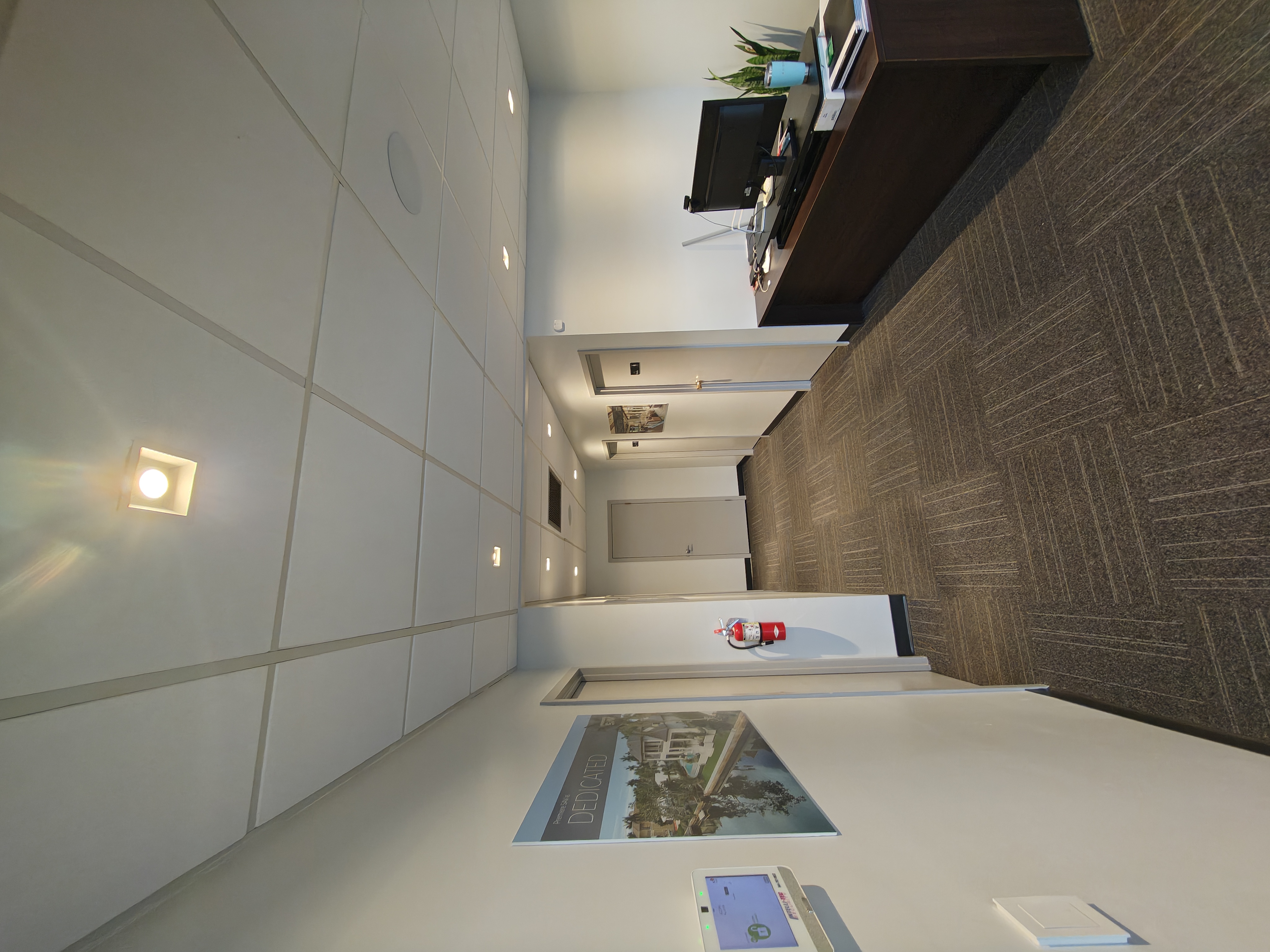 Recessed lighting along a commercial sales gallery corridor