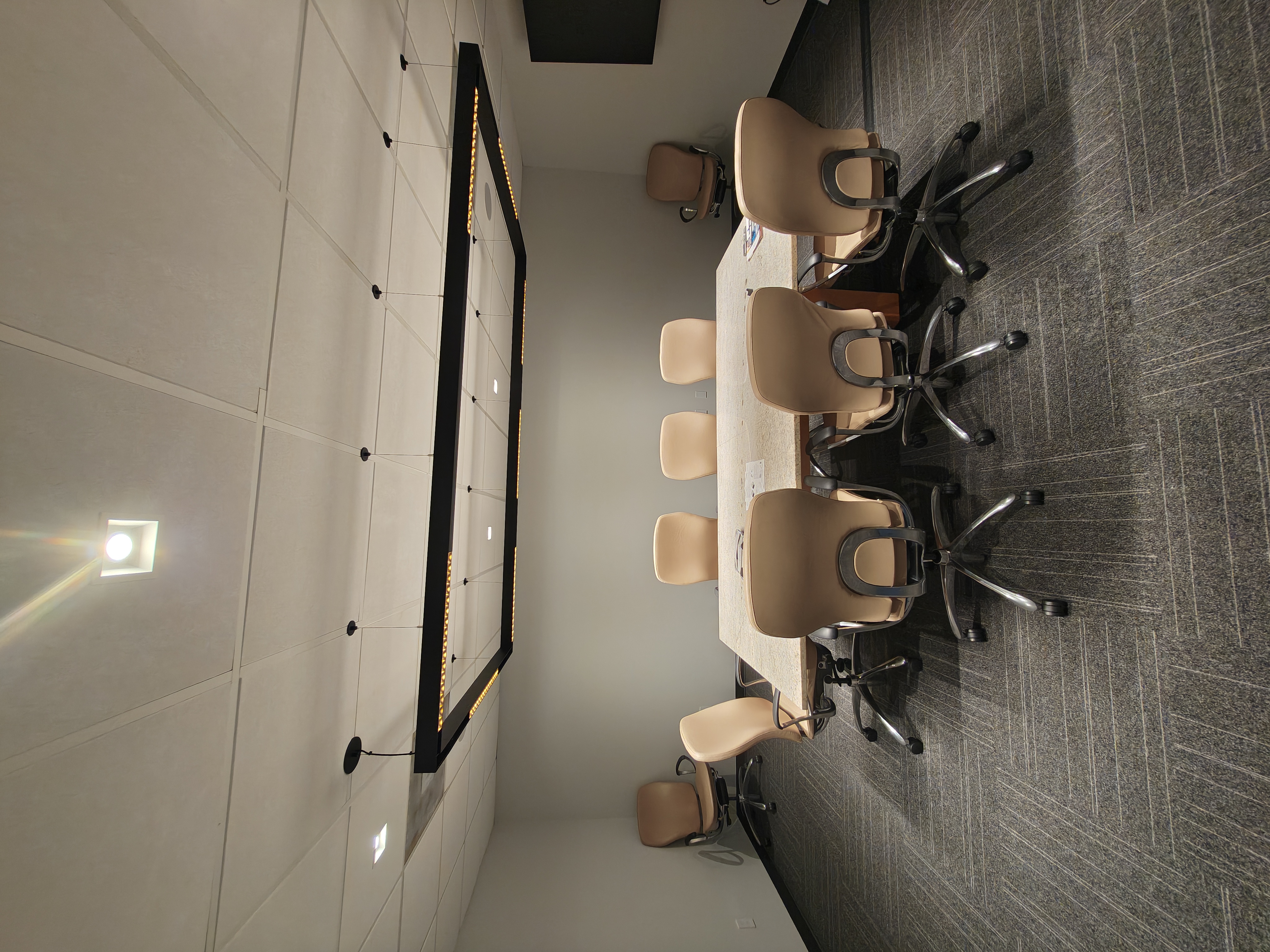 Conference room with an edge-lit LED-framed feature above the table