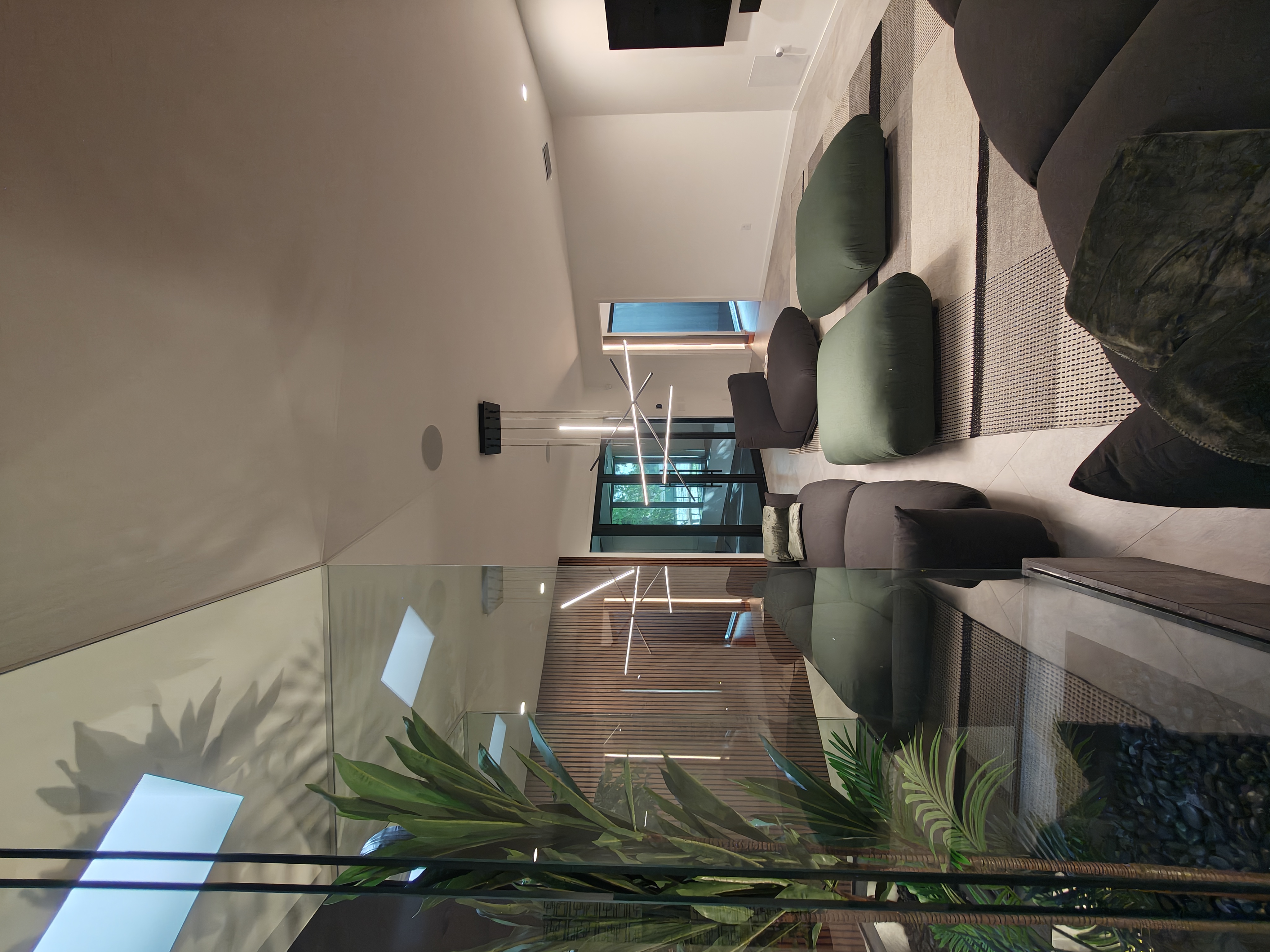 Suspended linear lighting across a vaulted great room