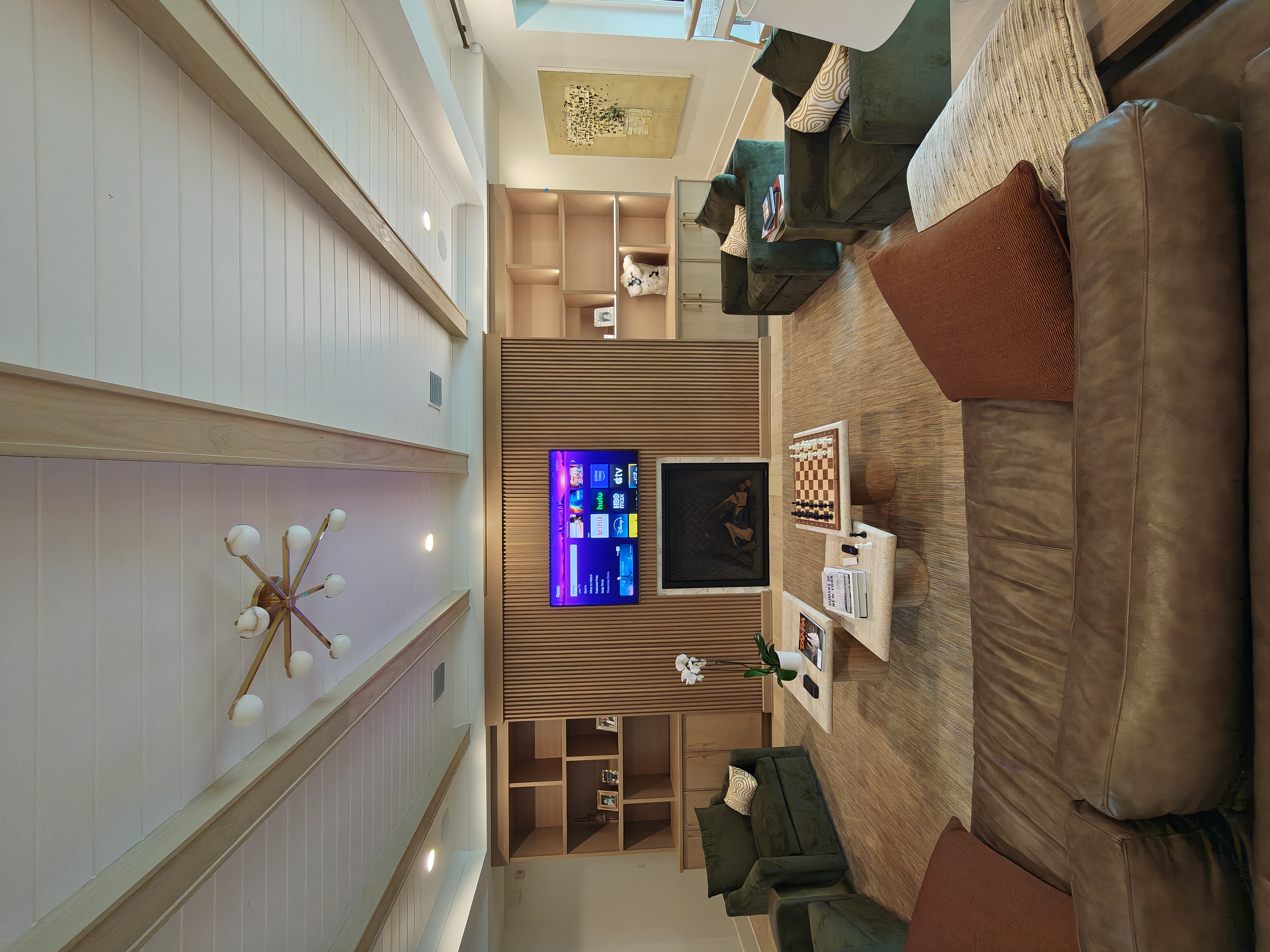 Starburst chandelier and recessed lighting in a modern living room