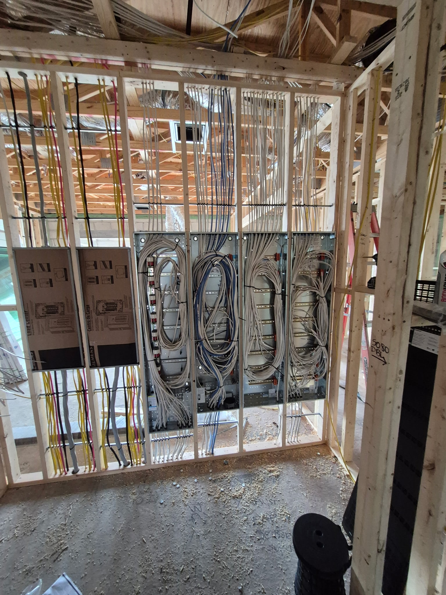 Structured low-voltage wiring and data panels roughed into a framed wall