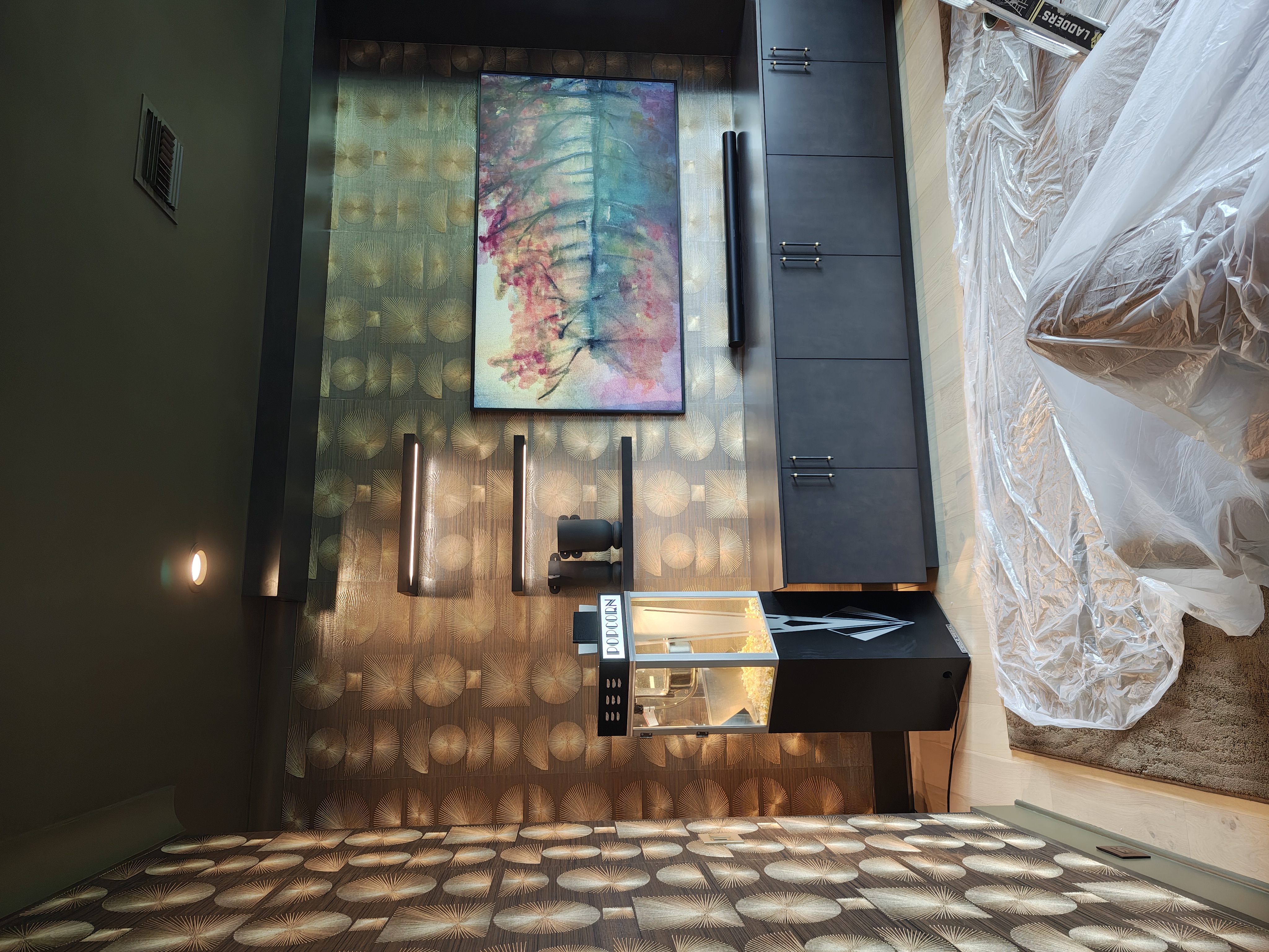 Accent lighting on a textured feature wall above a floating backlit vanity